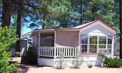 Tall Pines shade this Cavco Park Model with full-length covered deck great for entertaining. Comes completely furnished & ready for move in. Easy care landscaping with split rail fencing, gravel driveway and storage shed with workbench & shelving. Just