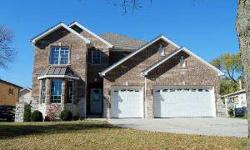 Beautiful and spacious brick and stone home with open floor plan, features a gourmet, eat-in kitchen, first floor den or 5th bedroom, 4.5 baths, stone fireplace, brick paver patio and 3 car garage. Extensive high end finishes include granite countertops,