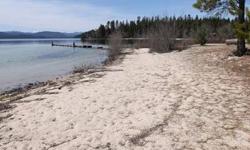 100 feet of frontage on deeded waterfront sandy beach on pristine Priest Lake. Flat and level lot with Southwesterly exposure. Mature evergreens make this a parklike setting. Great view. Coolin sewer district serves the property. Excellent home site for