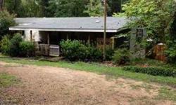 Buyer to verify all dimensions. Call owner for easy showing. Nature loving lots of birds and deer come around, quiet country setting with hardwood trees; Magnolia, Holly and Oaks. Welcoming front porch, and enclosed back patio. Investment opportunity