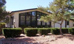 Ready to move in triple wide with 2 BR/2BA and den/library room. Enclosed Arizona room is heated and cooled not included in the 1512 square feet.Extra long 1 car garage has a seperate workshop, built-in storage units and new garage door.The back yard is