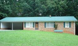 three beds 2.5 bathrooms brick ranch style home with renovated metal roof (2006). Large corner lot just outside of city limits. Hard wood floors, double carport, unfinished basement with full size bathroom,.(Needs toilet) Listed well below tax value.Greg