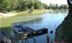 Lakefront lot which is flat and easy to build on. Has a floating dock to put you boat right next to this lot. About 22 stair steps to the floating dock Home will have a view of the lake if built in the back. Wooded lot with 2 others available for sale.