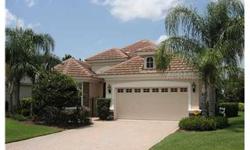 Upgraded "Chamonix" model by Neal in the Country Club of Lakewood Ranch with serene lake views. Enter thru the courtyard to this beautiful stone and stucco home featuring a oversized ceramic tiled great room with built-in entertainment center. Seperate