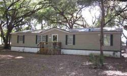 Beautiful oak trees surround this 1998 4BD/2BA dwmh on 2.63 fenced acres. Extensively remodeled bathrooms, newer metal roof, laminated wood flooring and newer french door refrigerator all add to the appeal of this home. Spacious, split floor plan offers a