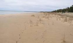 These two contiguous Lake Michigan lots off Michibay Road are a true rarity and together provide 200' of broad sand beach for your summer enjoyment. The most easterly lot has almost a natural place for a driveway and there are several excellent possible
