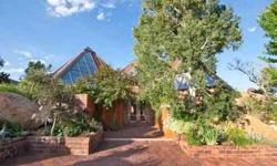 Manitou Springs at its finest! This home is a sanctuary with the most amazing views of Pikes Peak and city lights. This home begins with a beautiful enclosed courtyard and slate entry through double doors imported from Italy. Inside you will find a