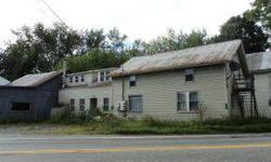 At approximately $90,000 under a recent assessment, this property is priced to sell. It offers so many options and possibilities! Currently 6 units and a 2 bay commercial garage. The septic is permitted for 7 bedrooms and the buildings/units can be