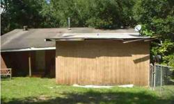 ** small brick home w/ wood floors on corner lot w/ mobile home in back yard ** lot could be subdivided as it was 2 lots at 1 time ** brick home needs work and is being sold as-is ** trailer is currently vacant and city may not allow to be re-occupied **