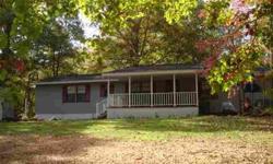 Peace & Tranquility! Very private, wooded location on 8.29 acres with small creek and a spring. 3 BR, 2 BA doublewide has large front porch and wonderful screened porch on back to enjoy the scenery & wildlife. House sits back from road and driveway has