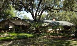 Scenic and serene is this delightful Florida lakefront ranch home that has been recently renovated. Enter through the private gate into this tropical paradise with extensive landscaping and oak trees. The floor plan includes three bedrooms, three full