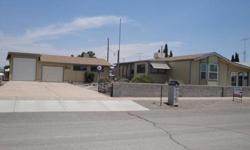 Very Nice single wide manufactured home with large sunroom in Deming Estates. Has detached garage and an additional RV Garage with a large workshop. Care free desert landscaping. 45+ Community has Restrictrice covenenants, 24 hour volunteer patrol and HOA
