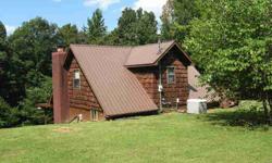 therew is a large barn that could house boats and extra vehicles, or toys for the lake. Also, an extra storage building for overfow from the house or lawn equipment. there is on bedroom on the main level with a full bath and the kitchen is located in the