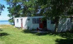 Cute 2 bedroom trailer just waiting for new memories to be made. Beautiful lake front lot with no road inbetween. Sandy beach for swimming and all your waterfun needs. Amazing views and awesome sunsets. Storage shed 10 X 20. Nice private lot Listing agent
