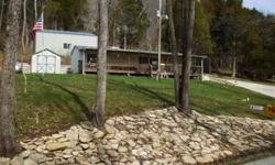 Hillside estate with huge garage built seperately.. 5 Acres overlooking Laughery Creek on the Dearborn County Side. Park like setting across the road on the creek that is shared with the neighbors Paved Drive and car parks and paved up to the garage. No