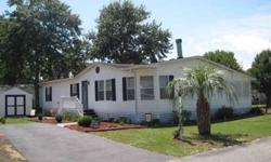 Gorgeous Doublewide manufactured home in the quiet 55 and older community of Inlet Oaks Village with it's own clubhouse and pool. 3 BR 2 Baths with spa tub and shower, enclosed solar screened back porch with hot tub, 10x12 utility shed with workbench and