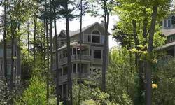 Imagine living in a luxurious tree house with L. Michigan views?that?s what this stunning three story home in The Cottages at Brook Hill (Homestead) has to offer and more! Enjoy the blue lake views from the living room, master suite, guest suite and
