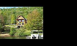 Beautiful Mountaineer Log Home on 45.33 feet of lakefront with a Type A Dock permit and views from almost every room. With the front being almost all glass, you can enjoy the four seasons of Deep Creek Lake with just a glance. Four master suites, granite