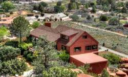 Soar Above the Rest!! A steep private drive leads you to this rock-top historic home. Built in 1955, quality constructed into it's own magnificent red rock, and fashioned with up-to-date conveniences. Secluded on 2-1/2 acres, bordered by national forest,