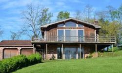 This sweet Chalet home in need of ALOT of TLC would be a nice Lake home this Summer and for Summers to come! Living room with vaulted ceiling, fireplace, lots of windows, 2 or 4 bedrooms, family room, wraparound deck, oversized 2 car garage. Gated