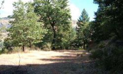 Very private wooded 13.47 acres with lots of views. Two possible building sites already cut in with more area available for larger sites. Septic system already in, water rights to the creek and power running by the parcel. Build you dream home or just set