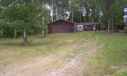 heavily wooded lot with mobile home and 2 stall garage, used as a cabin, on zipple bayListing originally posted at http