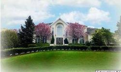 Palatial brick front estate in "Marlboro Woods" with circular driveway, exquisite beveled glass double entry doors leading you into the grand two story foyer with dramatic staircase. Gorgeous hardwood flooring throughout. New gourmet kitchen featuring top