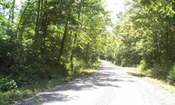 67.50 surveyed Acres with Rustic Hunting Cabin, Barn and nice fully stocked pond. Property is mostly wooded with aprox 5 acres clear and in grass. Property fronts 2 county maintained gravel roads and has well water. Timber was cut aprox 5 yrs ago. This