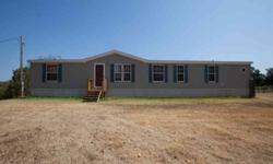 Country living at its best just off Hwy 75/This doublewide mobile home sits on almost 6 acres/FHA approved foundation/open floor plan with 4 bed, 2 full baths/2 living rooms/Fireplace/large eat in kitchen w/island, breakfast bar, pantry/laundry