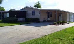 TURNKEY" 2/2 IN THE VILLAGES! Well maintained, U shaped kitchen with lots of storage, closet pantry and eat-at table/counter, dining room off kitchen, great room with sliding glass doors out to vinyl enclosed lanai, large master bedroom suite with French