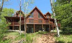 The perfect home, land and water. Located on crystal-clear Razorback Lake! The lake is over 70% state owned. This andquot;Wildernessandquot; Half Log Home has absolutely everything to make all your dreams come true. Large chefs kitchen with Viking range,