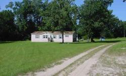 This well maintained manufactured home has vaulted ceilings, a great room, corner woodburning fireplace, dining room, a large island kitchen with lots of cabinet space, large covered back deck. It is nicely situated on an improved 5 acre parcel in