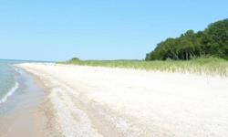 Permitted prime Lake Michigan parcel with easy pathway to a wonderful wide and sandy Lake Michigan beach! No bluff or steps! A beautiful private drive winds through hardwood and pine forest and reminds that you are in coveted Leelanau County far from the