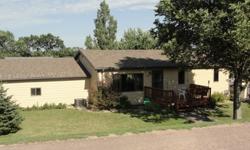 Small town living; get more home for your investment! 1978 Rambler, on a 66 x 165 lot. The house has cement board siding (2009) and many new windows. It has a front deck and a basement walkout and features a lower level kitchen. This 4 bedroom and 2