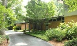 Large contemporary home has open floor plan. Giant wooded lot .086 acres with tons of landscaping features. Circle driveway with decor features. In the rear a long covered patio. Solarium (18X13) great for plant lovers. All rooms are large with tons of