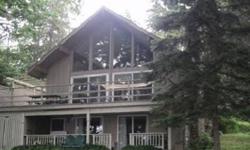 Charming Chalet on 100 of Big Green Lake ... Own your own 3 bedroom, 2 bath glass and cedar home set on a deep lakefront lot with beautiful mature trees and gradual frontage. Youll love the open concept living space with beautiful views of sparkling Green