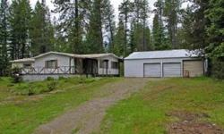 3 Bedroom,2 Bath manufactured home on 6.75 acres. Fireplace and wetbar in family room. Detached shop with room for two cars plus a separate workshop area. Lots of trees. Very private.Listing originally posted at http