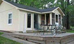 Cute-as-a-button little two-bedroom cottage on St. Clair Lake - a small, completely unspoiled Lake in the famous Chain O'Lakes. Neat and nicely maintained, with newer garage, the cottage features its original knotty pine interior - classic up-north retro