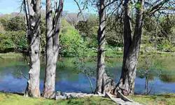 Flat lot in a access controlled community in the middle of Wimberley. Access to river front park with beautiful large oak trees.