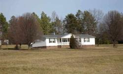 Nice, large doublewide w/addition on 4.6 acres. Beautiful setting with horses next door! Home sits way back from road and would also make a great small horse farm. Asphalt drive to both front & back of home. There is a double carport and 2 storage