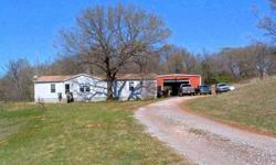 a BIG 30X40' STEEL FRAMED- METAL SIDED0 BARN POWERED WITH 220 AND HAS H HIGH DOORS TO DRIVE THROUGH, aGREAT WOK SHOP. THE HOME IS BEAUTIFUL, FIRE PLACE, MOTHER INLAW PLAN MASTER BATH HAS A SEPERATE BIG 4X4 STALL SHOWER + A BIG GARDEN TUB. KITCHEN IS AN