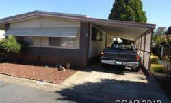 Great location in Oak Shadows Mobile Home Park, remodeled kitchen with custom oak cabinetry, ldry space in closet, One bedroom PLUS den (no closet), large FR with slider to deck, 2 car carport with shed, 2 car garage.Listing originally posted at http