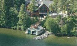 Magnificent Adirondack style lake house features grandfathered 2 bay 36'x32' boathouse with observation/entertainment deck above, sandy beach, 30' outside boat slip, 6 bedrooms and privacy. Features impressive great room with beautiful beamwork, grand