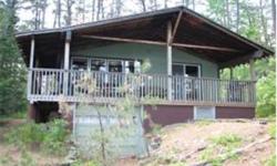 Ossipee Lake's Beautiful Broad Bay. Here is a classic, solid,4 season cottage with a great "Lake Feel" and nice front porch overlooking the bay and Loon Island.Nice private wooded lot. The owner has taken very good care of this home with many updates over
