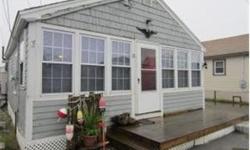 Adorable beach cottage with many updates. Sunny and bright. Open living / dining / kitchen with laminate flooring. Newer cabinetry and countertops in kitchen. Cozy reading nook. Stacked washer/dryer. Deck. New roof. Updated electrical. 2 blocks to the