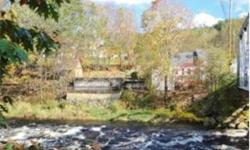 Once used as the toll house for the West Henniker covered bridge, this 2 bedroom home has an ideal, elevated riverfront location above the Contoocook River. Enjoy the peaceful sound of the rushing river from the two-tiered decks high above the river's
