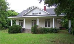 Charming columned 2 story white frame home built in 1922 has lg front porch,wide entry w/beautiful stairway,formal LR&DR,Sep brkst w/built in china cabinet,2BRs,Sunrm dn,wide hallway up w/2BRs.Picturesque 5.1 acres w/century old trees!Being Sold "As Is"