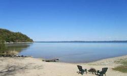 Spectacular estate size waterfront building site just 6 miles from Traverse City on Old Mission Peninsula. -- Enjoy expansive East Bay views from your choice of 2 ideal building sites and build your dream home without restrictive covenants commonly found