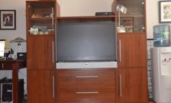 Large and very functional wall unit in fantastic condition. There is a copious storage for electronics, books, etc. Accommodates most 42" TVs.Dimensions