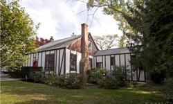 A staggered Tudor with unique charm set in lovely Larchmont Gardens-an area of great natural beauty and friendliness. Beautiful beamed ceiling in Living with fireplace, 4 bedrooms, 3 baths. The private yard features a deck and patio off the playroom.